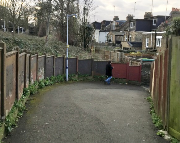 This unattractive, but essential urban alley links a suburban rail station (seen on the top left) to a neighbourhood (right).&nbsp; The alley is short but until recently was narrow and dark and therefore avoided by women.&nbsp; Whilst still unattractive, widening it and adding street lighting means that users can walk down it and still be clearly seen from one end or the other at all times (the old line can still be seen in the pavement)